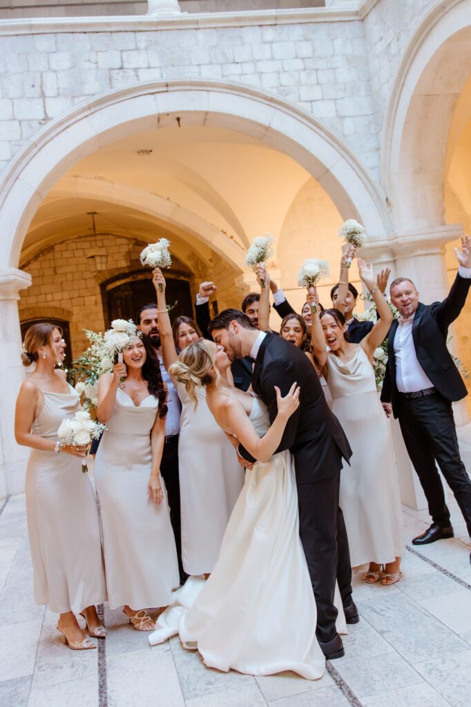 Newlyweds sharing their first kiss at a wedding in Dubrovnik Croatia